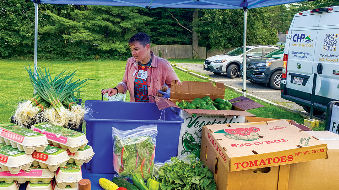 Ambrose Clausen sets up a mini farm stand outside a CHP practice.